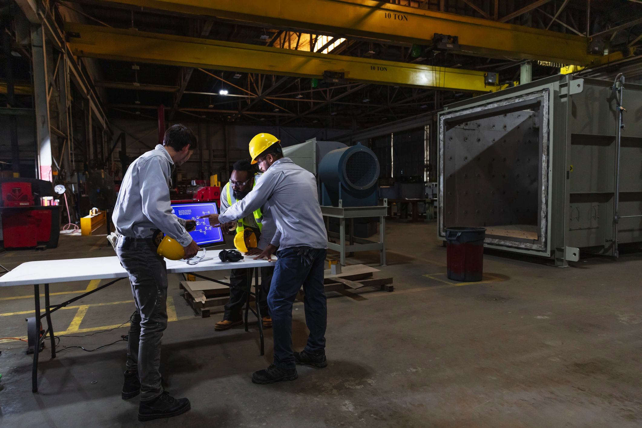 Engineering team reviewing production information on the factory floor